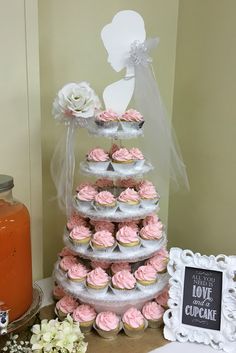 cupcakes are stacked on top of each other in the shape of a wedding cake