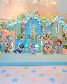 an image of a birthday party setting with balloons and animals on the stage set up