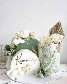 a table topped with vases and flowers next to a sign that says kimmies 5th