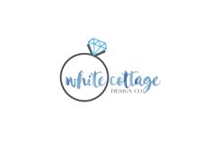 the white cottage design co logo, with a diamond on it's center piece