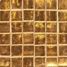 a close up shot of gold colored glass tiles