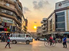 people walking and riding bikes on a city street