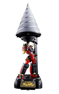 a toy robot is standing on top of a stand