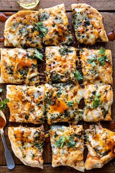 a pizza cut into squares on top of a wooden table