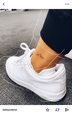 a person with a small tattoo on their ankle