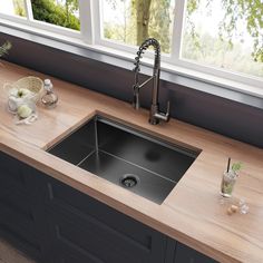 a kitchen sink sitting on top of a wooden counter