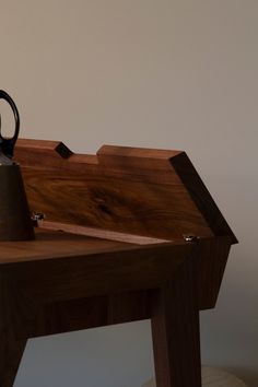 a tea pot sitting on top of a wooden table