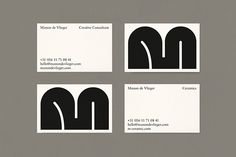 three business cards with black and white designs on them, one for the letter m