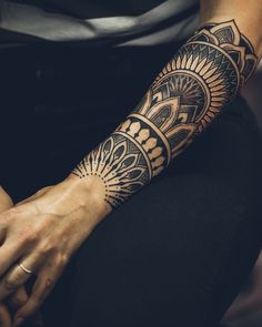 a woman's arm with a tattoo on it that has an intricate design in the middle