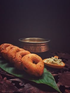 some food is sitting on a leaf next to a bowl