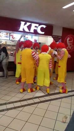 group of clowns in yellow and red outfits