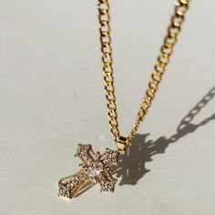 Our Miraculous Cross Necklace is the perfect symbol of faith and elegance. The cross pendant hangs on a stylish 14K Gold Filled curb chain. The Miraculous Cross Necklace is perfect for that statement piece you are looking to add to your collection.  Product Details 16" 3.5mm 14k Gold-Filled Curb Chain with 2" Extender Adjustable Gold Plated Cross Pendant Necklace, Gold Plated Cross Pendant Necklace With Adjustable Chain, Gold Plated Chain Necklace With Cross Pendant, Gold Plated Cross Chain Necklace, Gold-plated Cross Pendant Necklace With Chain, Yellow Gold Clavicle Chain Necklace With Cross Pendant, Gold Plated Cross Pendant Chain Necklace, 14k Gold Cross Necklace With Adjustable Chain, Elegant Gold Cross Necklace With Chain