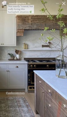 a kitchen with an oven, stove and counter tops in white painted cabinetry next to a rug