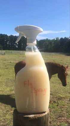 a bottle of milk with a horse in the background