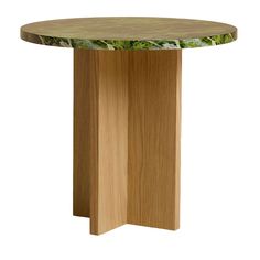 a round wooden table with green leaves on the top and bottom, against a white background