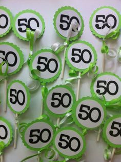 green and black number 50 cupcake toppers on sticks