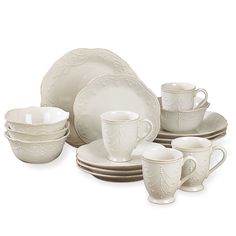 a set of white dishes and cups