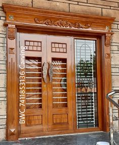 the front door to a building with two glass doors and wrought iron grills on each side