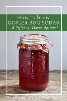 a jar filled with red liquid sitting on top of a wooden table