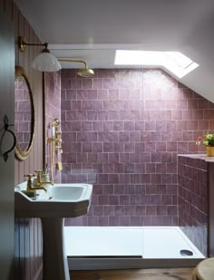 a bath room with a sink and a bath tub next to a shower head mounted on a wall