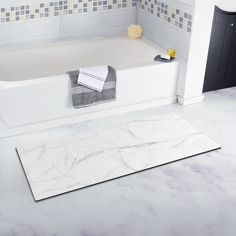 a white bath tub sitting inside of a bathroom