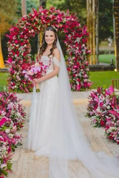 a woman in a wedding dress standing next to flowers