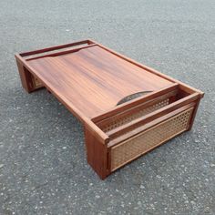 a wooden coffee table sitting on the ground