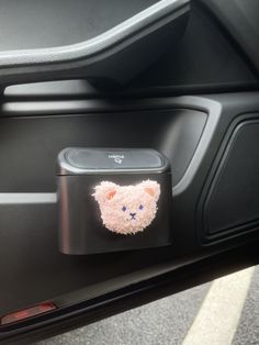 a car door handle with a teddy bear sticker on it