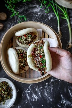 a person is holding up some food in a bowl