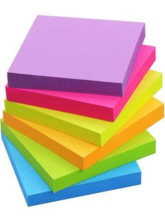 a stack of colored post - it notes sitting on top of each other in front of a white background