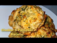 cheddar and parmesan biscuits on a white plate with the words cheddar & parmesan biscuits