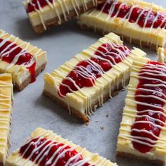 several pieces of cheesecake with raspberry toppings on a baking sheet, ready to be baked