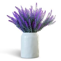 a white vase with purple flowers in it