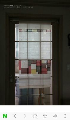 an open door with a window covered in multicolored squares and rectangles