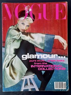 a magazine cover with a woman sitting on a stool