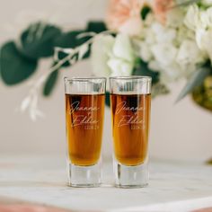 two shot glasses sitting on top of a table