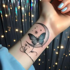 a woman's arm with a butterfly on the moon and stars in the sky