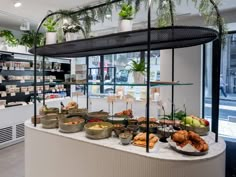 a display in a store filled with lots of different types of food on plates and bowls