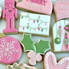 decorated christmas cookies are displayed on a table