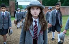 a group of young children wearing school uniforms