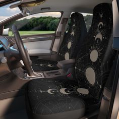 the interior of a car with black and white stars and moon designs on it's seat covers