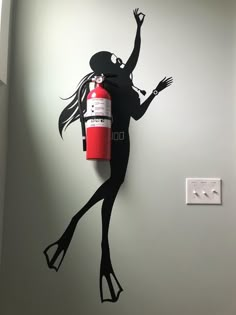 a wall clock made to look like a woman with a fire extinguisher