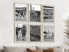 four black and white photos hang on the wall above a couch in a living room