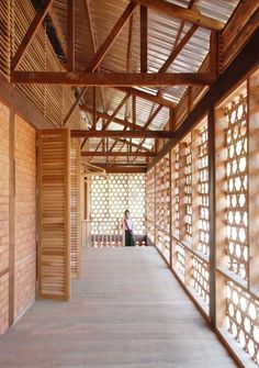 a person sitting on a bench in a room with wooden slatted walls and flooring