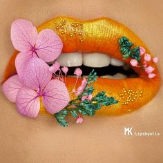 a woman's lips with flowers and leaves on the lip, painted in bright orange