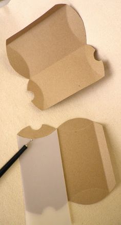 an open cardboard box with a piece of paper cut out next to it