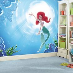 the little mermaid wall mural is shown in this children's room