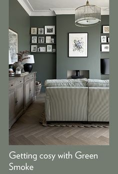 a living room with green walls and pictures on the wall above it that says getting cosy with green furniture