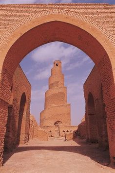 an archway leading to a tall brick structure