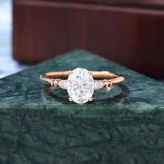 a diamond ring sitting on top of a green marble counter